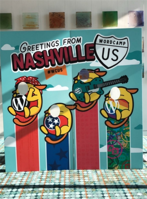 A board with face holes featuring the Wapuus of WordPress - Caption reads "Greetings from Nashville #WCUS"